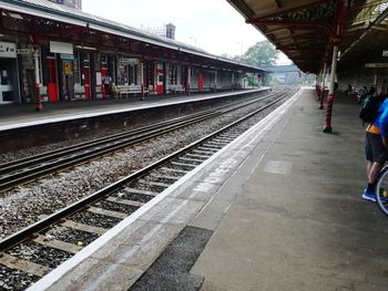 Rear view of man waiting at railroad station