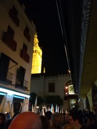 People in illuminated building at night