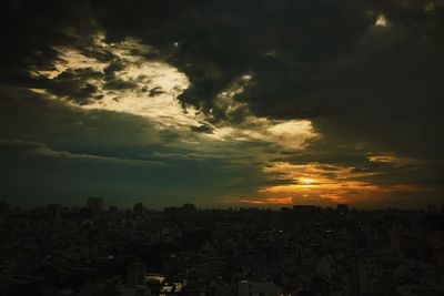 Silhouette buildings against sky during sunset