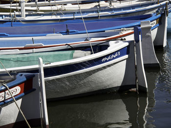 Sailboats moored in sea