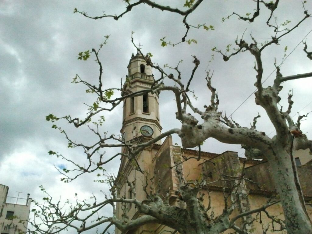 low angle view, architecture, sky, building exterior, built structure, bare tree, tree, branch, cloud - sky, religion, church, place of worship, spirituality, cloud, cloudy, history, old, cross