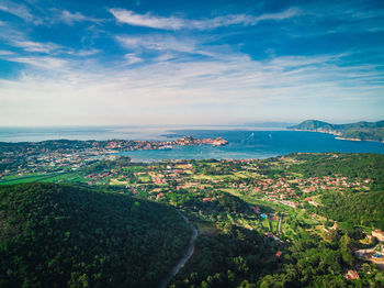 High angle view of townscape by sea against sky