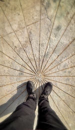 Low section of man standing on footpath
