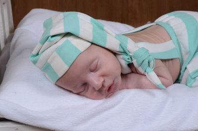 High angle view of baby boy sleeping on bed at home