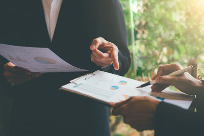 Midsection of business colleagues working at office