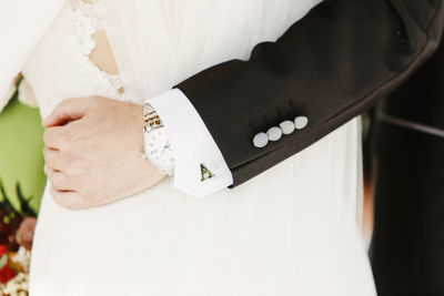 Midsection of couple standing during wedding ceremony