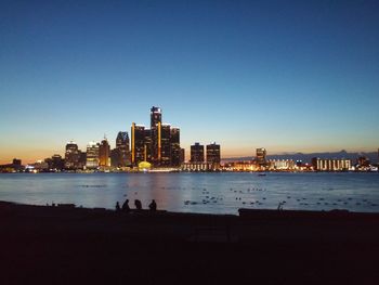 View of illuminated cityscape against clear sky