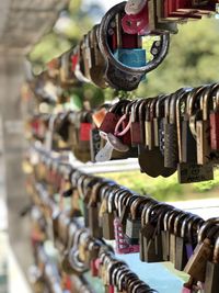 Close-up of padlocks hanging on railing