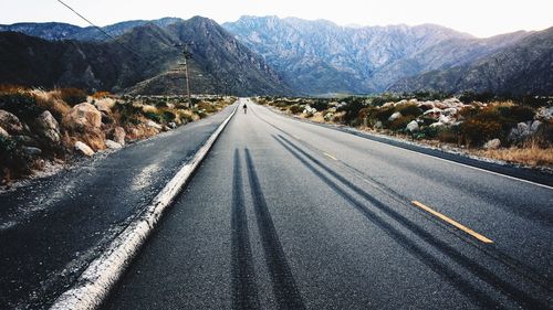 Road amidst mountains against sky