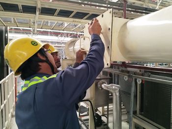 Men working on machinery in factory