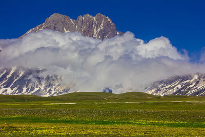 Scenic view of snowcapped mountains against sky