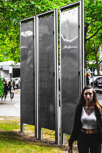 Full length of woman standing against plants