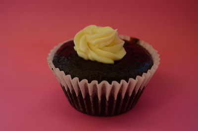 Close-up of cupcakes against red background