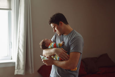 Man holding cat at home