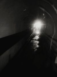 Illuminated tunnel at night