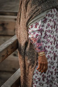 Midsection of woman standing by railing