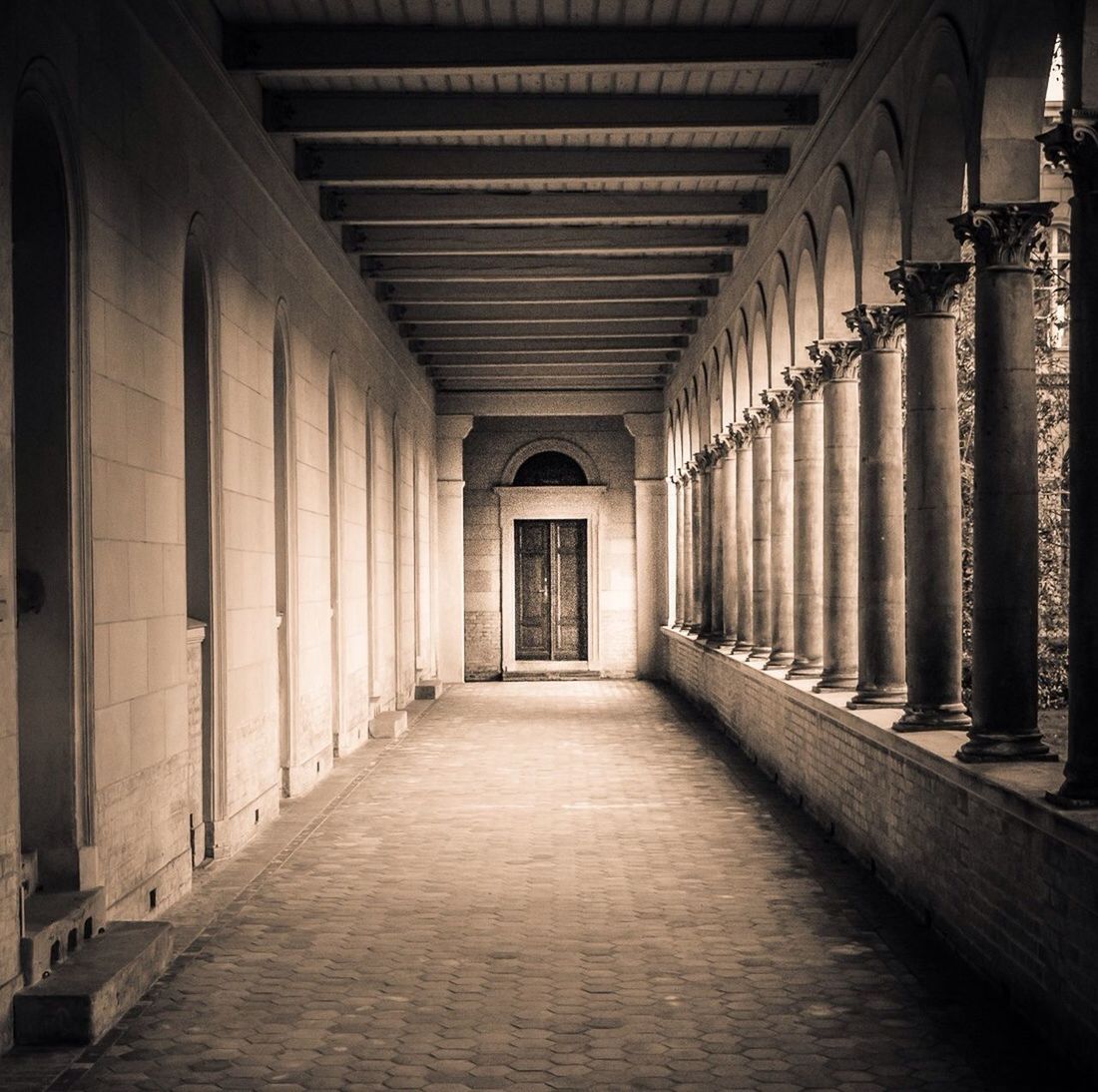 indoors, architecture, the way forward, built structure, corridor, diminishing perspective, ceiling, arch, architectural column, empty, colonnade, in a row, vanishing point, building, flooring, column, history, narrow, interior, old