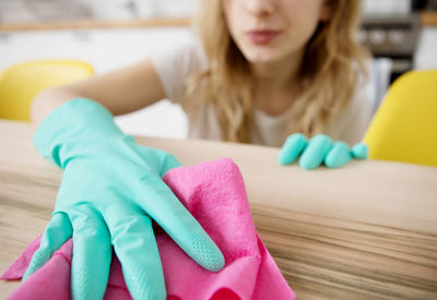 Close-up of girl sitting on table at home