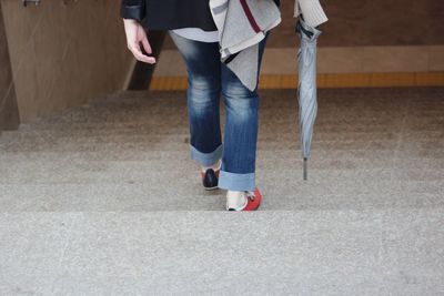 Low section of woman moving down on steps