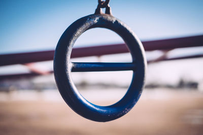 Close-up of metallic ring against sky