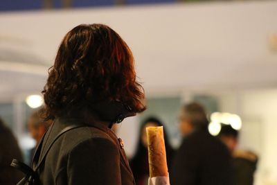 Rear view of woman standing against sea