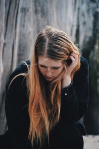 Young woman with hands hair