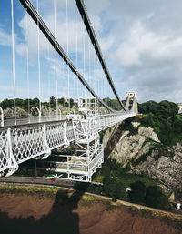 View of suspension bridge against cloudy sky