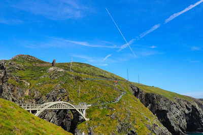 Low angle view of vapor trail against blue sky