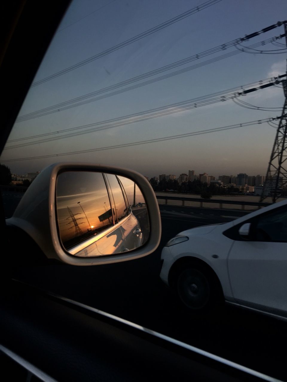 REFLECTION OF ROAD IN SIDE-VIEW MIRROR