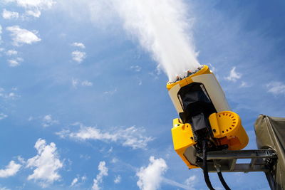 Low angle view of road signal against sky