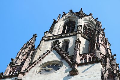 Low angle view of old building against clear blue sky