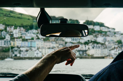 Close-up of man taking selfie in car