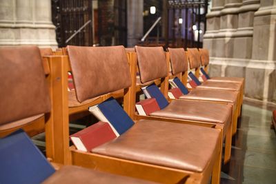 Bibles on empty row of chairs at church