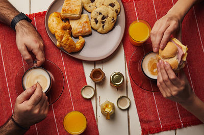 High angle view of people preparing food on table