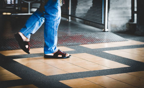 Low section of man walking on footpath