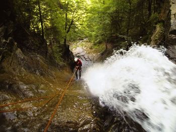 Blurred motion of people walking on road in forest