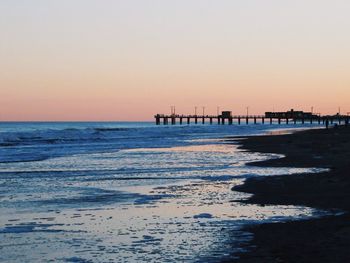 Scenic view of sea against clear sky during sunset