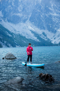 Paddle boarding on an alpine lake 