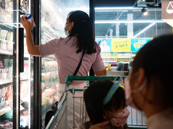 Rear view of woman looking at store