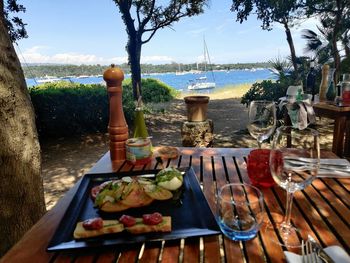 Food on table at beach against sky