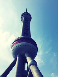 Low angle view of tower against cloudy sky