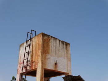 Low angle view of rusty metallic structure against clear sky