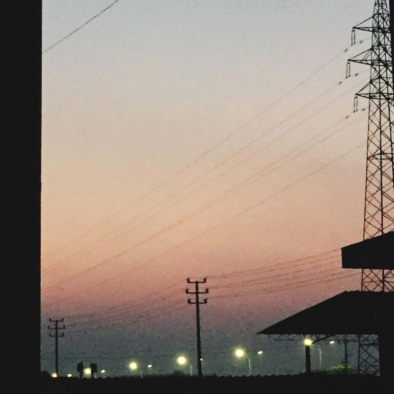 LOW ANGLE VIEW OF ELECTRICITY PYLON AT SUNSET