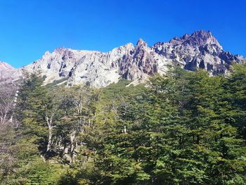 Scenic view of mountains against clear blue sky