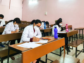 High angle view of people sitting on table