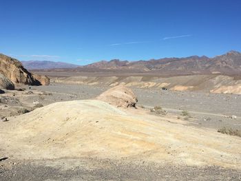 Scenic view of arid landscape against sky