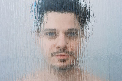 Portrait of man seen through glass