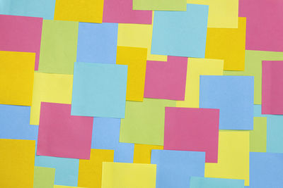 Multicolored sticky paper notes texture background, full frame