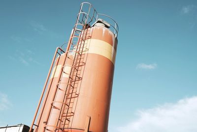 Low angle view of crane against sky