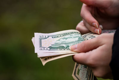 Midsection of person holding paper